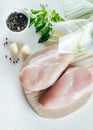 Raw chicken breast fillets on wooden board on table background Royalty Free Stock Photo