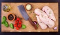 Raw chicken breast fillets on wooden cutting board with herbs and spices. Royalty Free Stock Photo