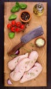 Raw chicken breast fillets on wooden cutting board with herbs and spices. Royalty Free Stock Photo