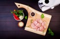 Raw chicken breast fillets on wooden cutting board with herbs and spices. Royalty Free Stock Photo