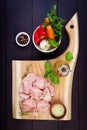 Raw chicken breast fillets on wooden cutting board with herbs and spices. Top view Royalty Free Stock Photo