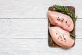 Raw chicken breast fillets on wooden cutting board with herbs and spices Royalty Free Stock Photo