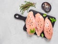 Raw chicken breast with fresh basil and thyme on black cuttingboard, copyspace Royalty Free Stock Photo