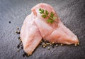 Raw chicken breast with herbs and spices on black plate - Raw uncooked chicken meat marinated with ingredients for cooking