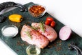 Raw chicken breast with rosemary, vegetables  and red pepper on green marble cutting board Royalty Free Stock Photo