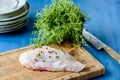 Raw chicken breast with the skin still on and some herbs in the Royalty Free Stock Photo