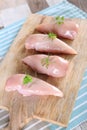 Raw chicken breast on wooden background