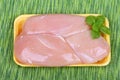 Raw chicken breast in plastic box