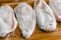 Raw Chicken Cutlets Dredged in Flour on a Cutting Board Royalty Free Stock Photo