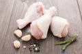 Raw chicken drumsticks and pepper, salt, garlic, rosemary on woo Royalty Free Stock Photo