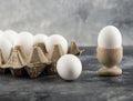 Raw chicken egg in eggcup with eggbox on a marble background Royalty Free Stock Photo