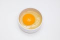 Raw chicken egg in a white cup standing on a white background Royalty Free Stock Photo