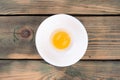 Raw chicken egg yolk is separated with white in a white bowl. Royalty Free Stock Photo