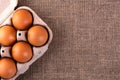 Raw chicken eggs in a basket on a jute cloth background Royalty Free Stock Photo