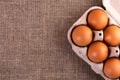 Raw chicken eggs in a basket on a jute cloth background Royalty Free Stock Photo