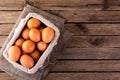 Raw chicken eggs in basket on wooden background Royalty Free Stock Photo