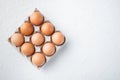 Raw chicken eggs in egg box  on white background  top view flat lay   with space for text copyspace Royalty Free Stock Photo