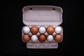 Raw chicken eggs in a package on a black background. Copy space. Space for text Royalty Free Stock Photo