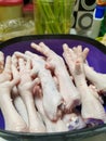 Raw Chicken Feet in a Purple Bowl