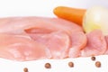 Raw chicken fillet cut into slices. Chilled chicken breast, carrots and onions isolated on a white background. Close up Royalty Free Stock Photo