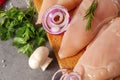 Chicken fillet with herbs, onions, mushrooms on a cutting board, poultry meat