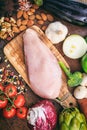 Raw chicken fillet on wooden background. Fresh, healthy, uncooked poultry on wood cutting board. Vertical photo