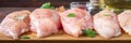 Raw chicken fillets on a cutting board against the background of a wooden table. Meat ingredients for cooking.. Banner Royalty Free Stock Photo