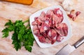 Raw chicken gizzards on wooden table Royalty Free Stock Photo