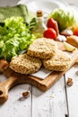 Raw chicken hamburger cutlet breaded with paprika and garlic. Homemade minced poultry cutlet with spices. Fresh lettuce leaves Royalty Free Stock Photo