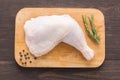 Raw chicken leg on cutting board on wood background Royalty Free Stock Photo