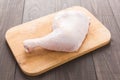 Raw chicken leg on cutting board on wood table Royalty Free Stock Photo