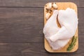 Raw chicken leg on cutting board on wooden background Royalty Free Stock Photo