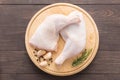 Raw chicken leg on cutting board on wooden background Royalty Free Stock Photo