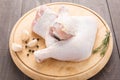 Raw chicken leg on cutting board on wooden background Royalty Free Stock Photo