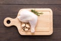 Raw chicken leg on cutting board on wooden background Royalty Free Stock Photo