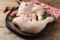 Raw chicken leg quarters and ingredients on wooden table Royalty Free Stock Photo