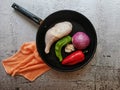 Chicken leg with vegetables on gray cement background