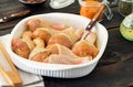 Raw chicken legs in baking dish on wooden table closeup Royalty Free Stock Photo