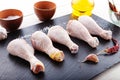 Raw chicken legs on a blackboard Royalty Free Stock Photo