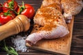 Raw chicken legs on a cutting board on a wooden table Royalty Free Stock Photo