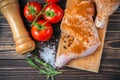 Raw chicken legs on a cutting board on a wooden table Royalty Free Stock Photo