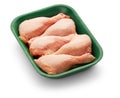 Raw chicken legs in a green tray over white background Royalty Free Stock Photo