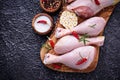 Raw chicken legs with spices and garlic. Royalty Free Stock Photo