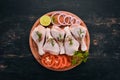 Raw chicken legs with spices and vegetables Royalty Free Stock Photo