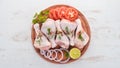 Raw chicken legs with spices and vegetables. Royalty Free Stock Photo