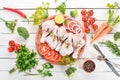 Raw chicken legs with spices and vegetables. Royalty Free Stock Photo