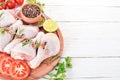 Raw chicken legs with spices and vegetables. Royalty Free Stock Photo