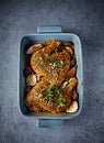 Raw chicken legs in spicy marinade with fresh herbs, garlic and shallots. Home cooking concept Royalty Free Stock Photo