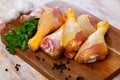 Raw chicken legs on wooden table Royalty Free Stock Photo