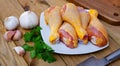 Raw chicken legs on wooden table Royalty Free Stock Photo